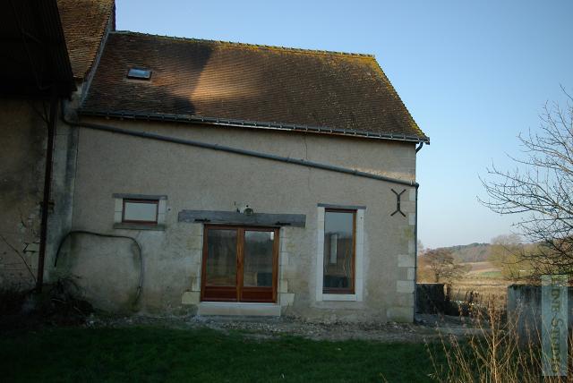 This is the back of the laiterie with one of the little slot windows replaced by a long thin lounge window which overlooks the orchard.
The lightpipe window can be seen in the roof